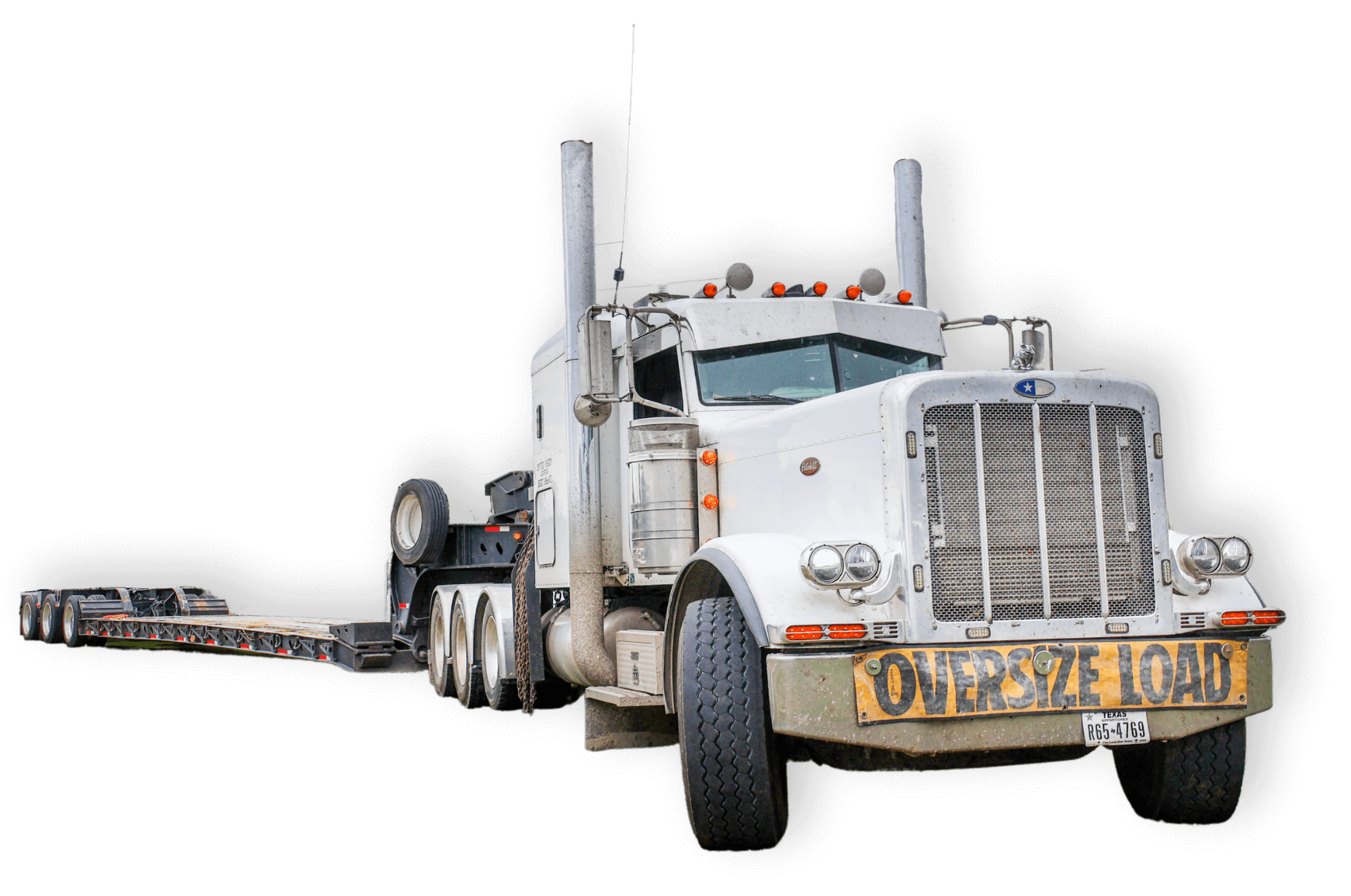 Gray heavy haul truck with trailer and oversize load banner on grill